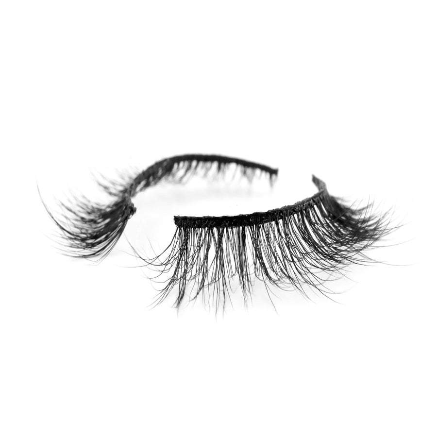 Suntarah Beauty 3D Faux Mink False Strip Lash in Style F-102  pictured at an angle against a white backdrop.  Lash appears light and wispy with a black band.