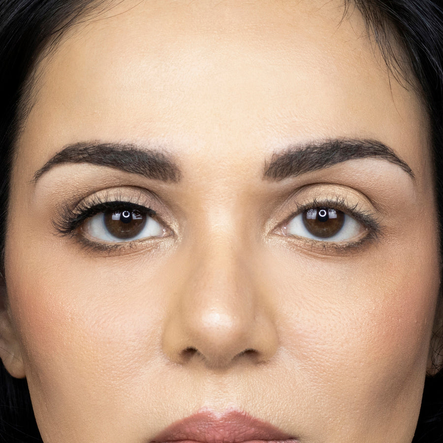 Close up of a young woman wearing Suntarah Beauty 3D Faux Mink False Strip Eyelash in Style F-101 on right eye only. There is a pleasing difference between her eyes. Eye with the false lash is slightly accentuated with a very natural looking wispy false lash.