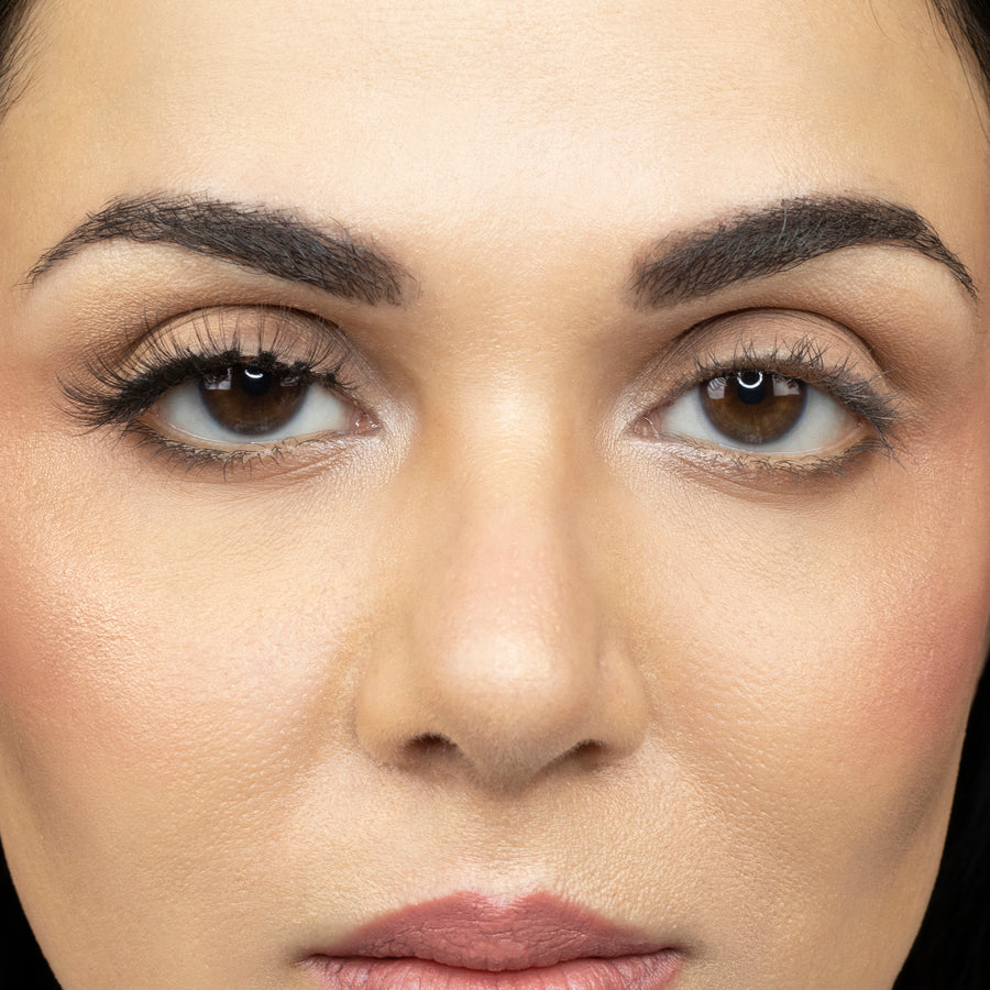  Close up of young woman wearing Suntarah Beauty 3D Ultra Light Synthetic Strip Eyelash in Style SL-330 on right eye only. There is a beautiful subtle difference between her eyes.  Her right eye is accentuated with the natural, wispy, airy, and fluttery lash.