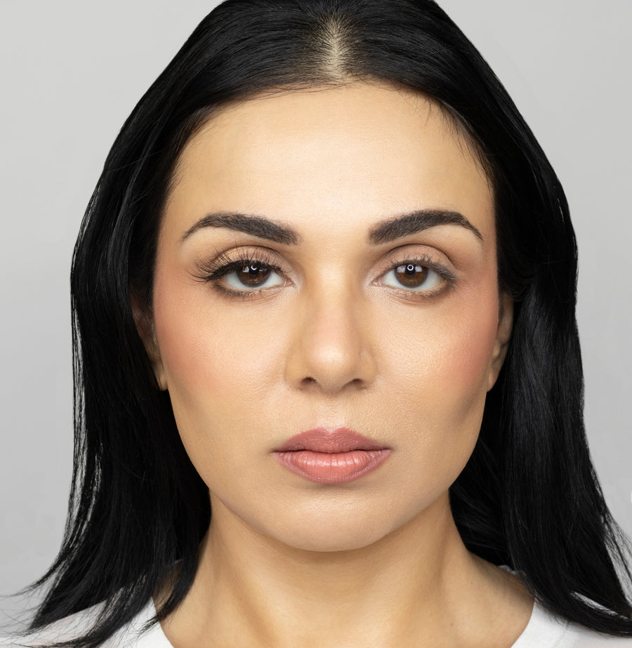 Full face of young beautiful woman wearing Suntarah Beauty Ultra Light Synthetic Strip Eyelash in Style SL-331 on right eye only.  There is a subtle difference in appeal between both her eyes.  Her right eye is  appears accentuated and slightly foxy with the airy and natural strip eyelash.
