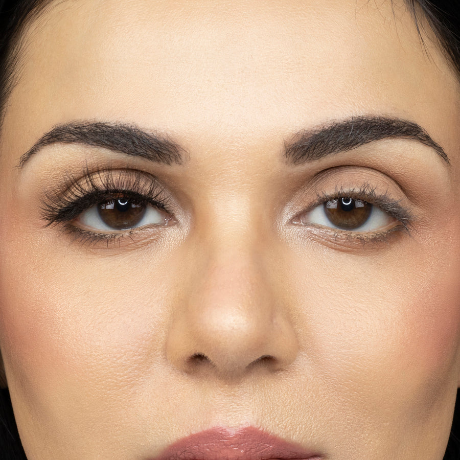  Close up of young woman wearing Suntarah Beauty 3D Ultra Light Synthetic Strip Eyelash in Style SL-334 on right eye only. There is a significant difference between her eyes.  Her right eye appears more open and accentuated with the wispy and fluttery lash.