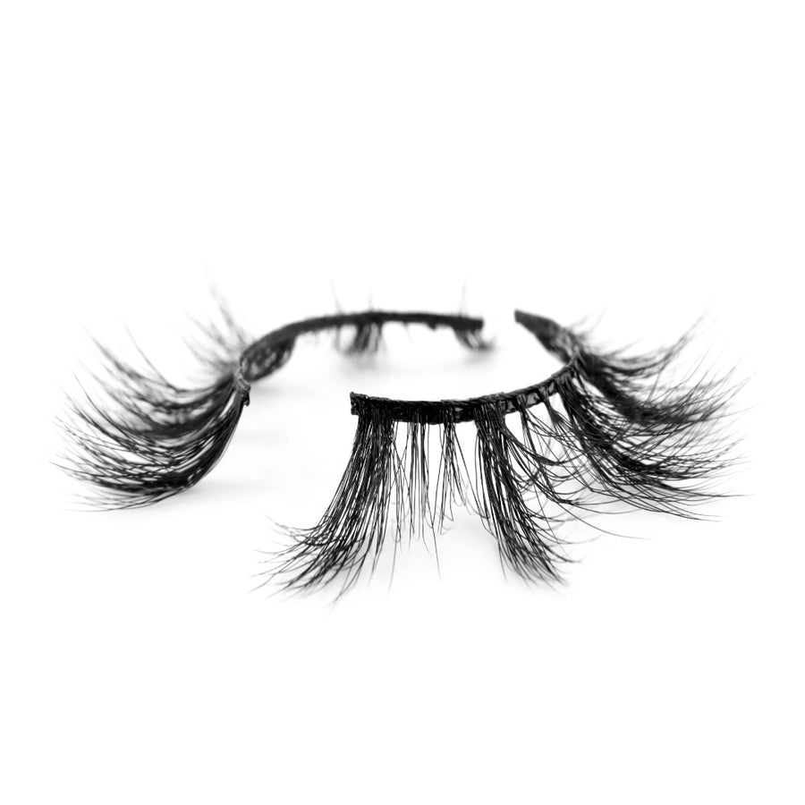 Suntarah Beauty 3D Faux Mink False Strip Eyelash in Style F-103 pictured at an angle against a white backdrop.  Lash has dynamic light and medium volume clusters, tapered shape,  and a black band.