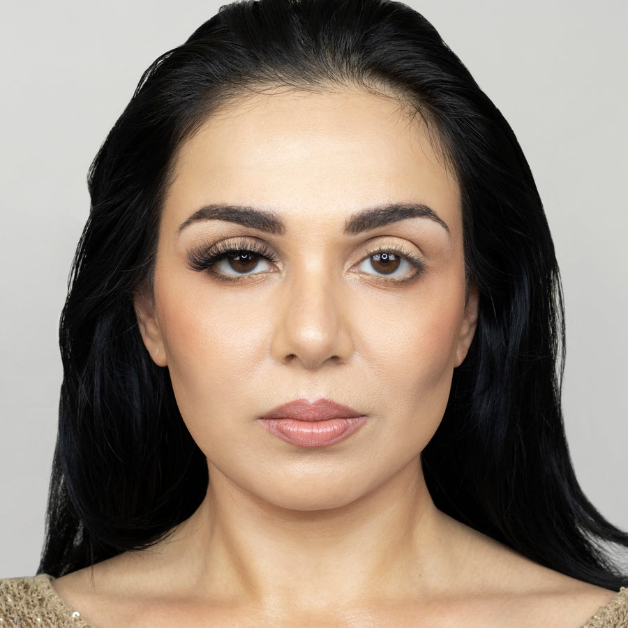Full face of a young beautiful woman wearing Suntarah Beauty 3D Faux Mink False Strip Eyelash in Style F-105 on right eye only. There is a significant difference between her eyes. Eye with the false lash is accentuated and has a cat eye appeal.