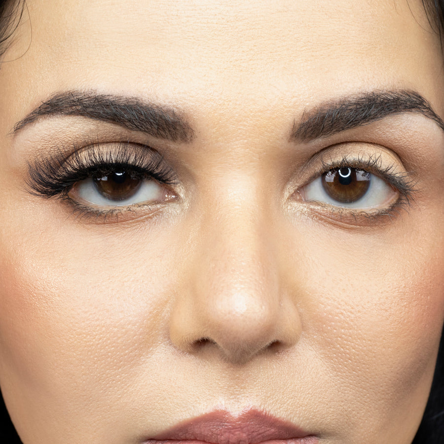 Close up of a young woman wearing Suntarah Beauty 3D Faux Mink False Strip Eyelash in Style F-105 on right eye only. There is a significant difference between her eyes. Eye with the false lash is accentuated and has a cat eye appeal.