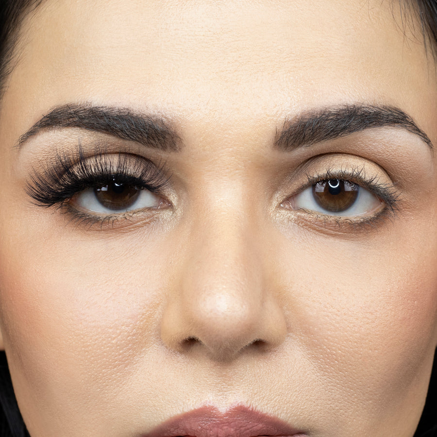 Close up of woman wearing Suntarah Beauty 3D Faux Mink False Strip Eyelash in F-107 on right eye only.  Woman is looking straight ahead. Photos shows significant difference between eye appeal, with right eye appearing much more accentuated with the glamorous, bold, and foxy false eyelash.