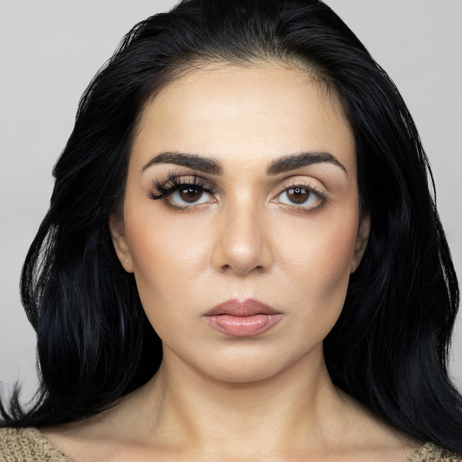 Full face of a young beautiful woman wearing Suntarah Beauty 3D Faux Mink False strip lash in F-108 on her right eye only. Left eye has no false lash. There is a significant difference in appearance between both eyes. Right eye's lash is quite accentuated and has a doll like look.