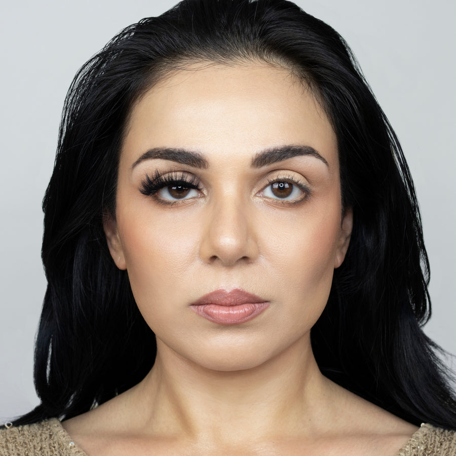 Full face picture of young beautiful woman wearing Suntarah Beauty 3D Faux Mink False Strip Eyelash in Style F-109 on right eye only. Image shows significant difference in appeal between both her eyes.  Her right eye is glamorously accentuated with a bold, wispy, and gorgeous false strip lash.