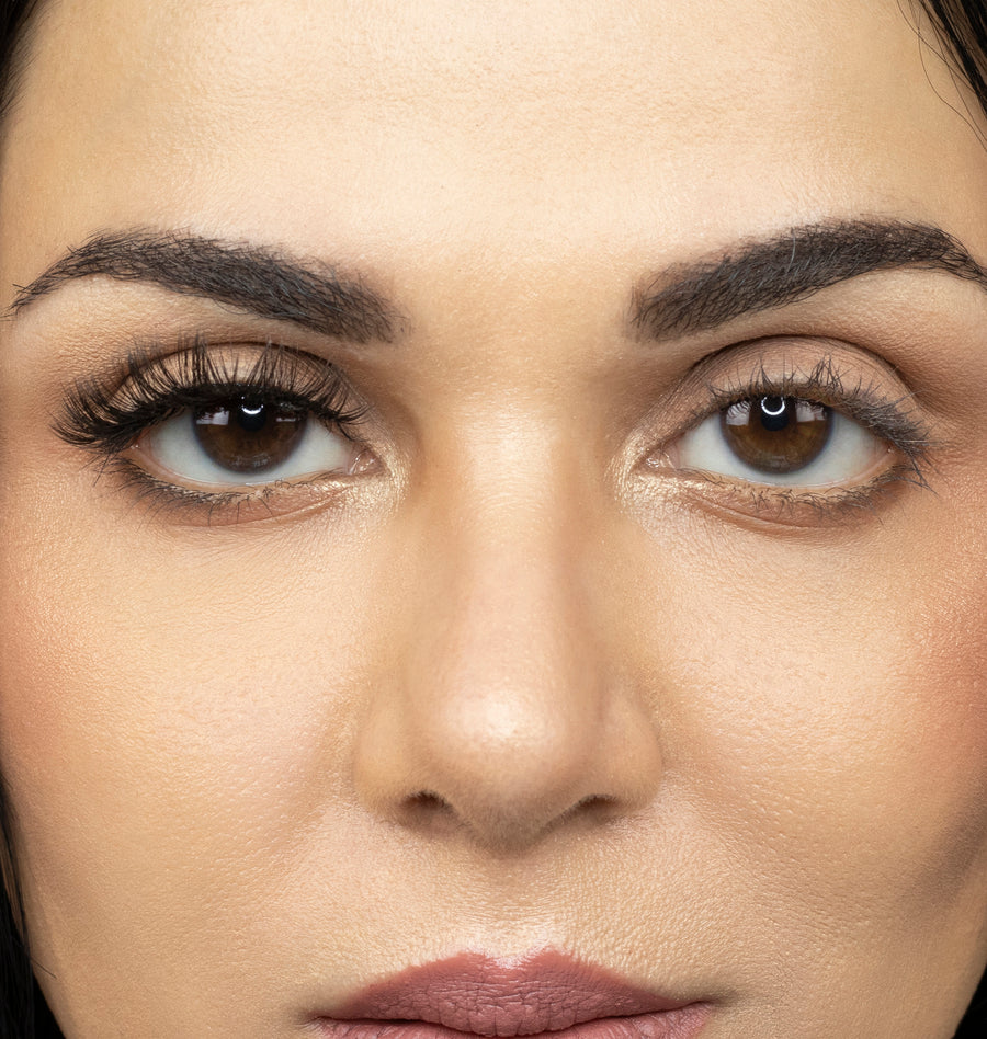  Close up picture of young woman wearing Suntarah Beauty 3D Premium Synthetic Strip Eyelash in Style S-223 on right eye only. There is a significant difference between her eyes.  Her right eye looks very glamorous and doll like.  False lash looks wispy, dramatic, and bold.