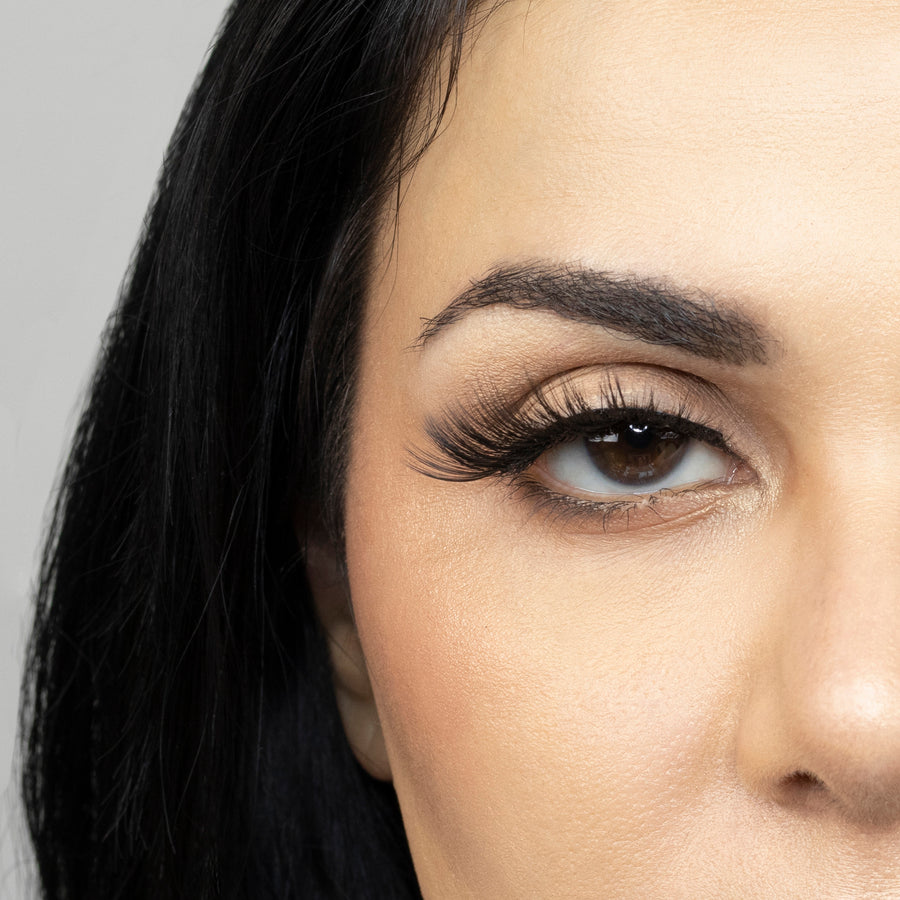 Close up of woman’s right eye while wearing Suntarah Beauty 3D Premium Synthetic false strip eyelash in style S-224. Woman is looking straight ahead.