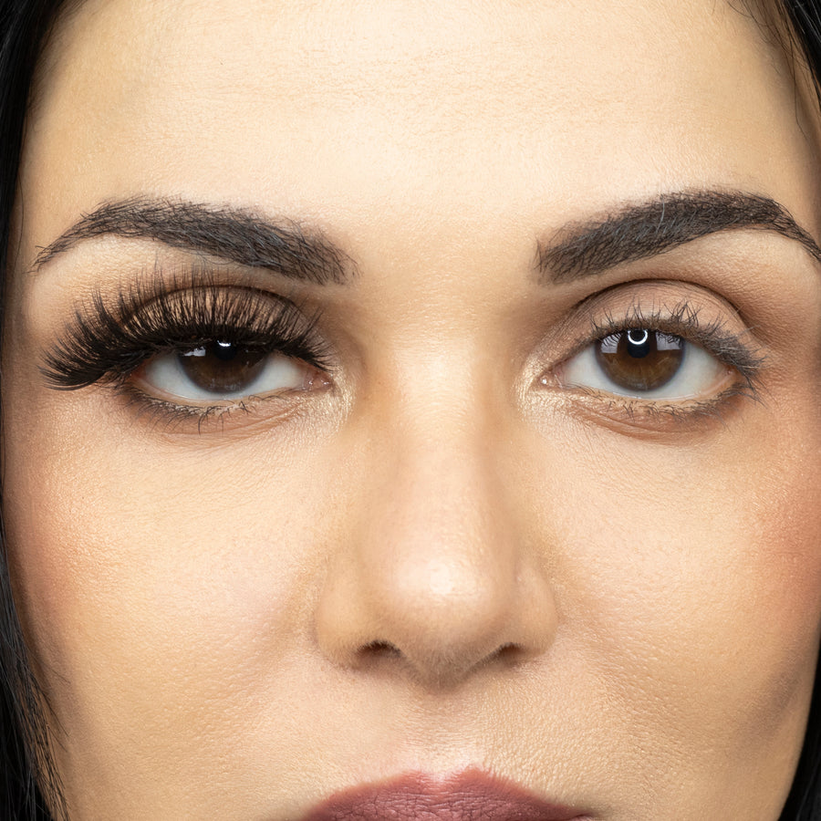  Close up picture of young woman wearing Suntarah Beauty 3D Premium Synthetic Strip Eyelash in Style S-225 on right eye only. There is a significant difference between her eyes.  Her right eye looks extremely dramatic and bold.  