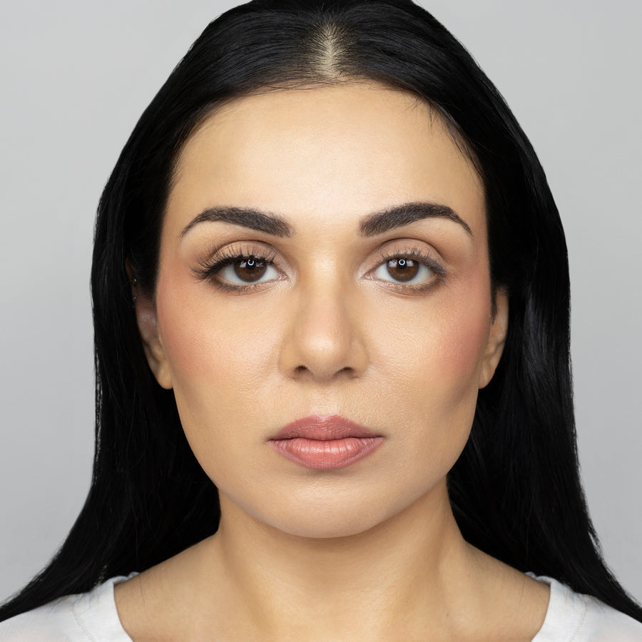 Full face of young beautiful woman wearing Suntarah Beauty Ultra Light Synthetic Strip Eyelash in Style SL-330 on right eye only.  There is a significant difference in appeal between both her eyes.  Her right eye is  accentuated with a wispy and fluttery false strip eyelash, perfect for the everyday.