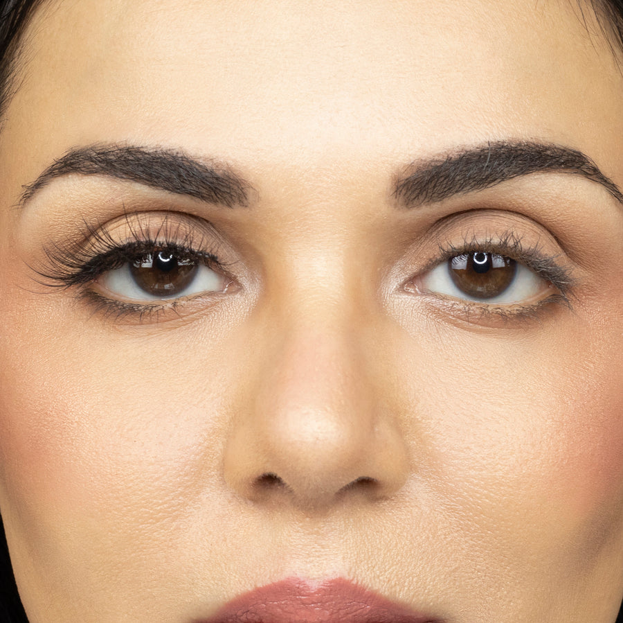  Close up of young woman wearing Suntarah Beauty 3D Ultra Light Synthetic Strip Eyelash in Style SL-331 on right eye only. There is a beautiful subtle difference between her eyes.  Her right eye is accentuated with the natural, wispy, foxy, and fluttery lash.