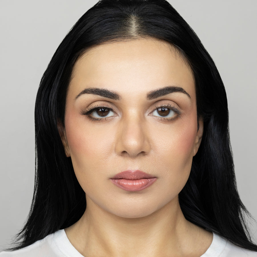 Full face of young beautiful woman wearing Suntarah Beauty Ultra Light Synthetic Strip Eyelash in Style SL-332 on right eye only.  There is a subtle difference in appeal between both her eyes.  Her right eye is  appears accentuated and foxy with the airy and natural strip eyelash.