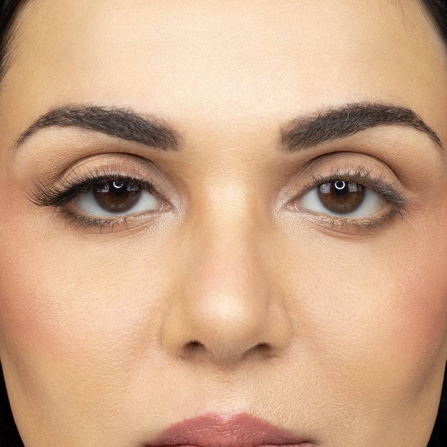  Close up of young woman wearing Suntarah Beauty 3D Ultra Light Synthetic Strip Eyelash in Style SL-332 on right eye only. There is a beautiful stunning difference between her eyes.  Her right eye is accentuated with the natural, wispy, foxy, and fluttery lash.