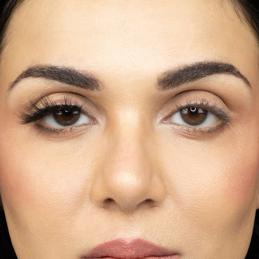  Close up of young woman wearing Suntarah Beauty 3D Ultra Light Synthetic Strip Eyelash in Style SL-333 on right eye only. There is a beautiful stunning difference between her eyes.  Her right eye is accentuated with the slightly bold, wispy and fluttery lash.