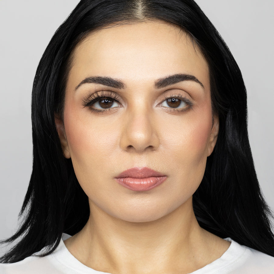 Full face of young beautiful woman wearing Suntarah Beauty Ultra Light Synthetic Strip Eyelash in Style SL-334 on right eye only.  There is a significant difference between her eyes.  Her right eye is appears more open and accentuated with the wispy and fluttery everyday lash.